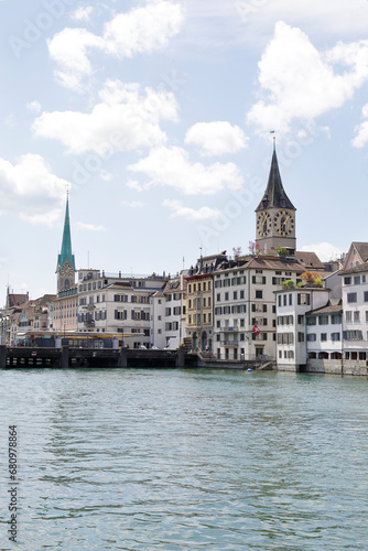 View of the historic city center with famous Saint Peter and FraumÃ¼nster Church, on the Limmat river. Zurich, Switzerland.