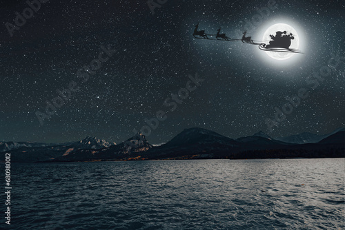 a Santa Claus flies against the background of the moon on Christmas Eve