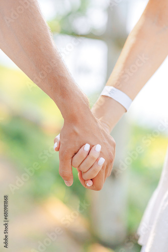 Newlyweds exchange rings, groom puts the ring on the bride's hand.