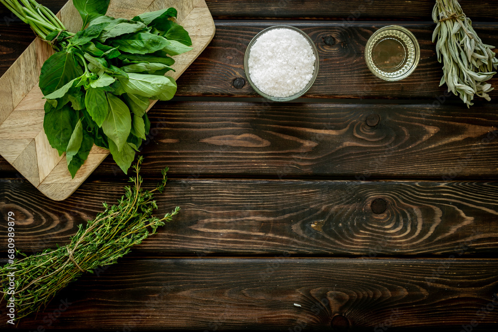 Cooking background with fresh green herbs on wooden board, top view Cooking background with fresh green herbs on wooden board, top view