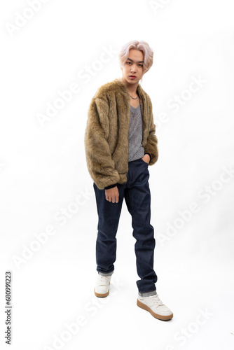 winter faux fur coat. Fashion portrait Asian young man. model, clothing and cosmetics. Young male model fashion lifestyle in fashionable clothing on isolated white background