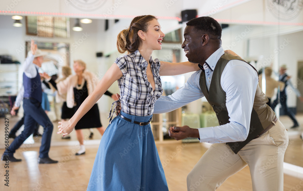 Obraz premium Woman with african man practising charleston dancing