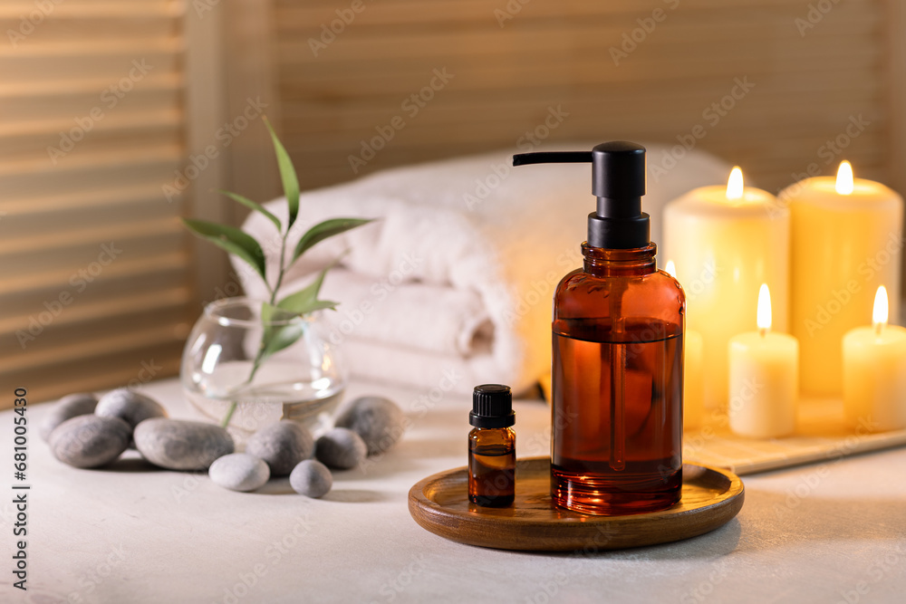 Beauty spa treatment items on white wooden table. Candles, stones, essential oils and towels. Cosy bath. Beauty spa treatment items on white wooden table. Candles, stones, essential oils and towels. Cosy bath.