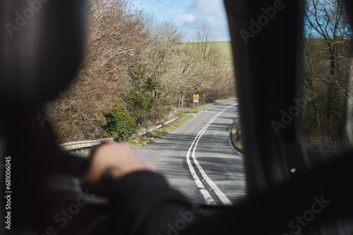 Rear passenger point of view from interior of car travelling, looking out the window on a country road - speed on single carriageway, trip concept photo