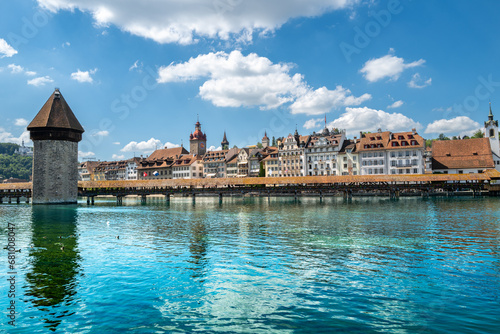 Lucerne, Switzerland - July 10, 2022: View of the Chapel Bridge in historic city of Lucerne,  Switzerland.  One of the main tourist attractions in the city center. photo