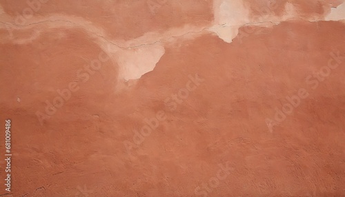 old terracotta painted stucco wall with cracked plaster backgro