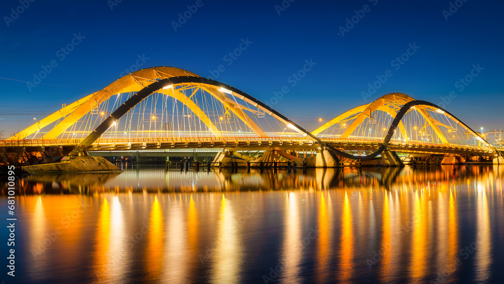 A bridge in the city at night. The bridge against the sky during the blue hour. Architecture and design. Amsterdam, Netherlands. Panoramic photography for design and background.. - obrazy, fototapety, plakaty 