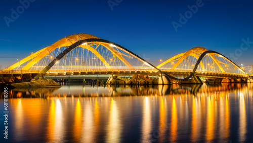 A bridge in the city at night. The bridge against the sky during the blue hour. Architecture and design. Amsterdam, Netherlands. Panoramic photography for design and background..