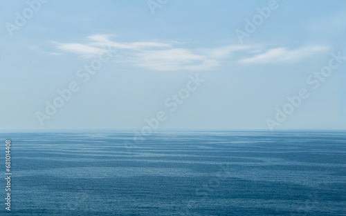 Seascape with blue-toned waves. Calm sea, white clouds, blue sky. Mediterranean Sea. Catalonia, Spain.