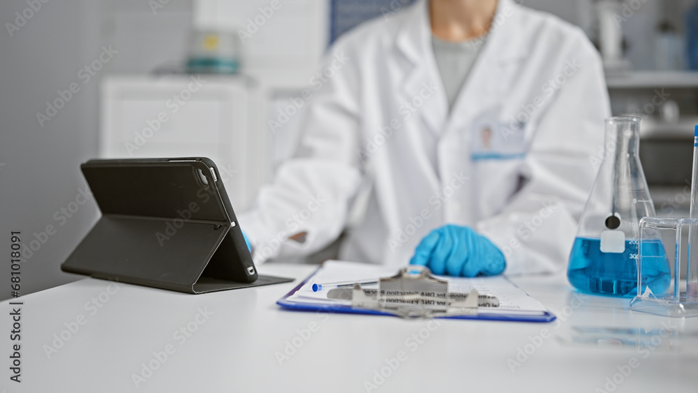 Hands of woman scientist using touchpad at laboratory Hands of woman scientist using touchpad at laboratory