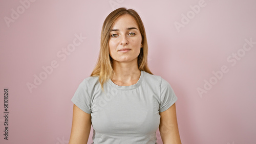 Tableau sur toile Artistic portrait of a serious young caucasian woman with blonde hair, standing
