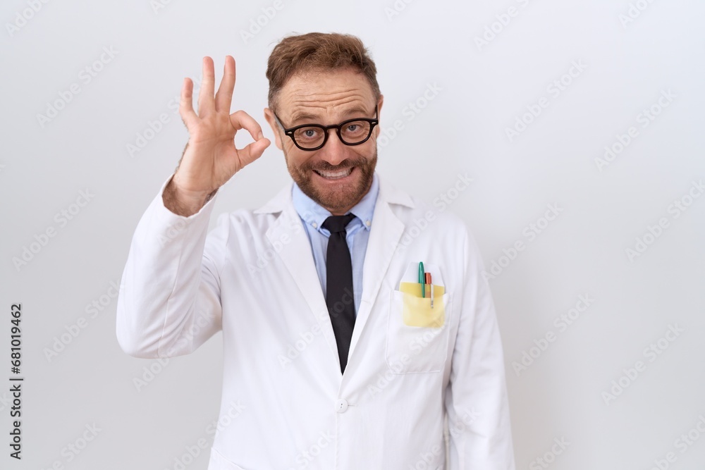 Middle age doctor man with beard wearing white coat smiling positive doing ok sign with hand and fingers. successful expression. Middle age doctor man with beard wearing white coat smiling positive doing ok sign with hand and fingers. successful expression.