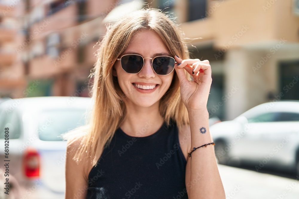 Young blonde woman smiling confident wearing sunglasses at street Young blonde woman smiling confident wearing sunglasses at street