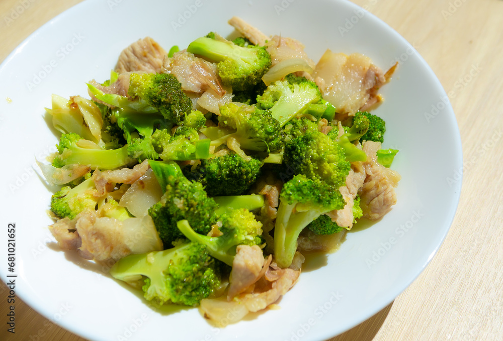 Stir-fried vegetables with pork , Broccoli stir with Thai food style in the white plate. Stir-fried vegetables with pork , Broccoli stir with Thai food style in the white plate.