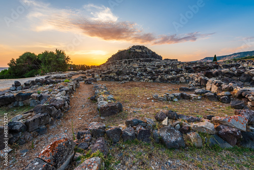 The bronze age fort UNESCO world heritage site Su Nuraxi di Barumini on Sardinia island during sunset.  photo