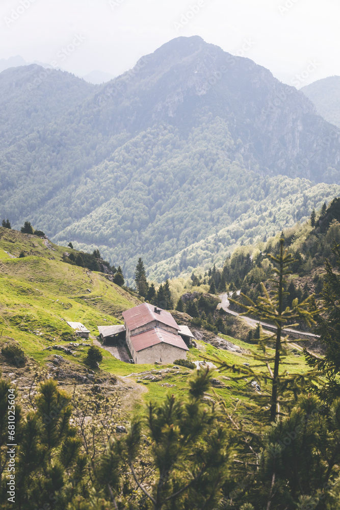 Obraz premium stone house in the mountains with woods background