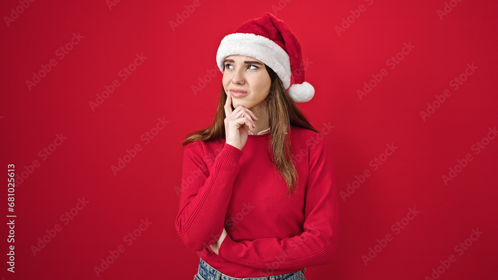Young hispanic woman wearing christmas thinking over isolated red background Young hispanic woman wearing christmas thinking over isolated red background
