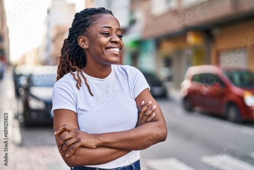 African american woman standing with arms crossed gesture at street photo