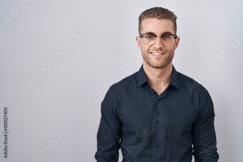 Young caucasian man standing over isolated background with a happy and cool smile on face. lucky person. © Krakenimages.com
