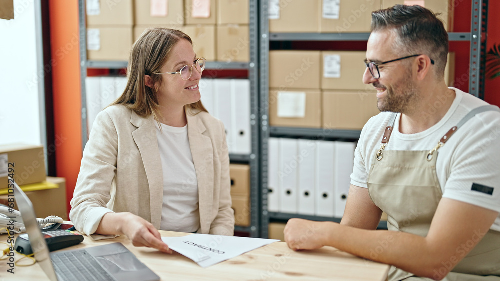 Fototapeta premium Young woman and man working on ecommerce on a meeting at office