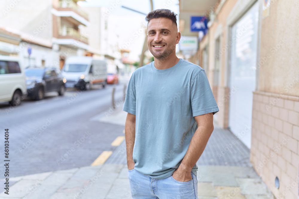 Young hispanic man smiling confident standing at street Young hispanic man smiling confident standing at street