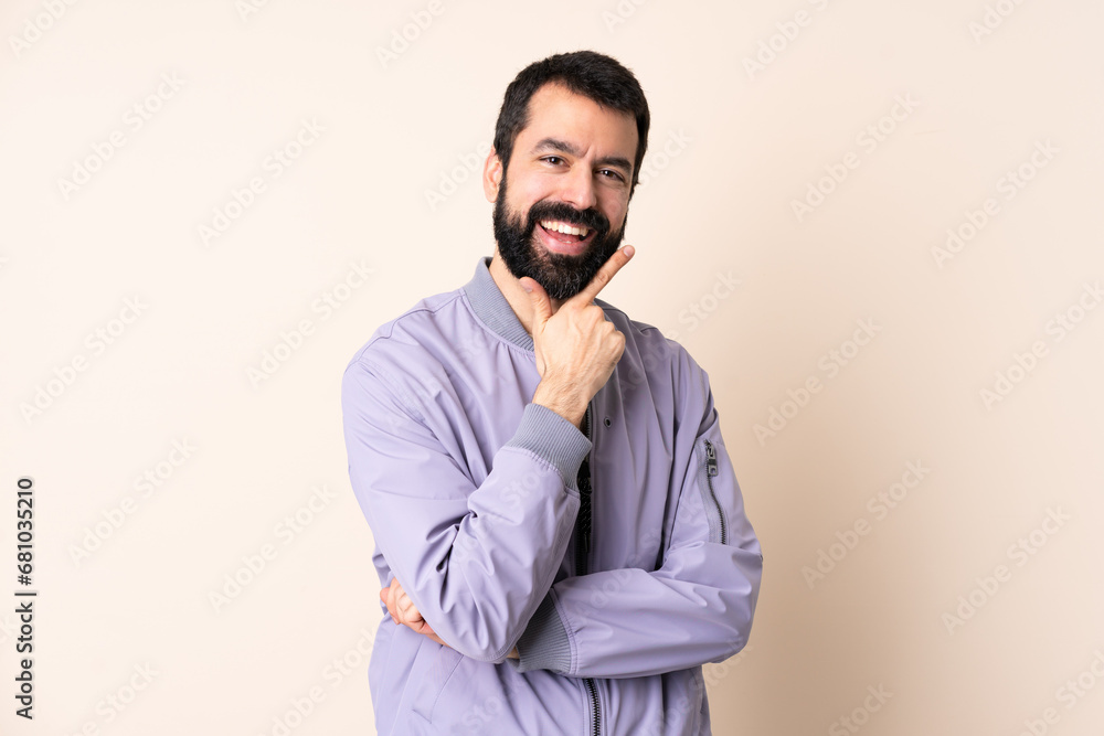 Caucasian man with beard wearing a jacket over isolated background happy and smiling Caucasian man with beard wearing a jacket over isolated background happy and smiling