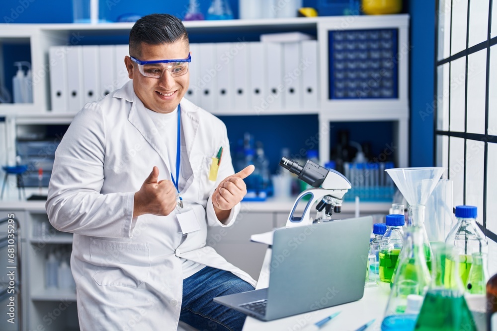 Young latin man scientist smiling confident having video call at laboratory