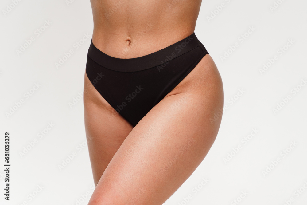 A woman with a beautiful feminine figure in black lingerie with overweight, cellulite and stretch marks. A woman with a beautiful feminine figure in black lingerie with overweight, cellulite and stretch marks.