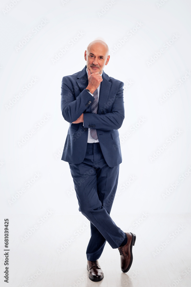 Full length of a mid aged businessman wearing suit and tie against isolated white backgroun Full length of a mid aged businessman wearing suit and tie against isolated white backgroun