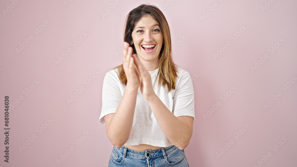 Young blonde woman smiling confident clapping applause over isolated pink background Young blonde woman smiling confident clapping applause over isolated pink background
