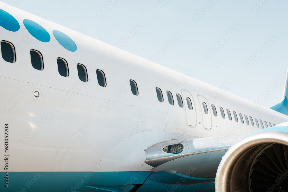 Close-up of an airplane on the runway, row of windows outdoors