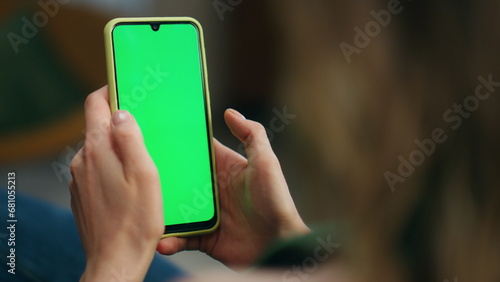 Woman hand swiping green phone screen closeup. Unknown relaxed girl scrolling photo