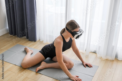 VR fit.Girl doing fitness in VR glasses at home,virtual reality exercise, immersive workout,VR sports,virtual gym