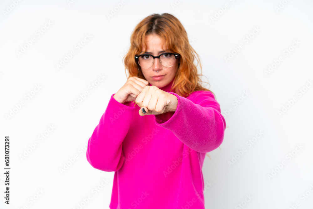 Young caucasian woman isolated on white background with fighting gesture