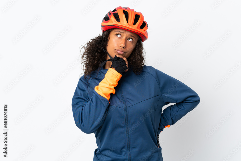Teenager cyclist woman isolated on white background and looking up - obrazy, fototapety, plakaty 