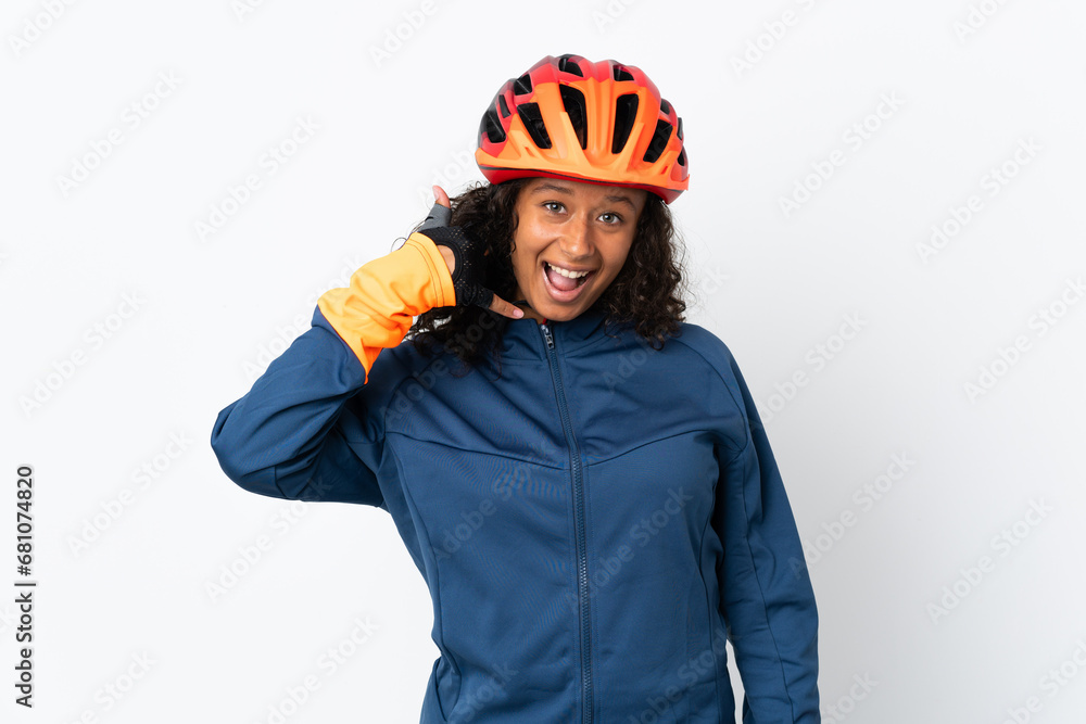 Teenager cyclist woman isolated on white background making phone gesture. Call me back sign Teenager cyclist woman isolated on white background making phone gesture. Call me back sign