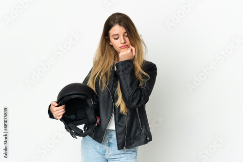 Woman holding a motorcycle helmet isolated on white background having doubts © luismolinero