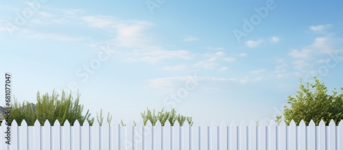 Partial opening on each side of a white picket fence Copy space image Place for adding text or design
