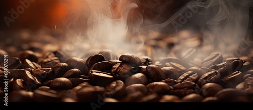 Roasting coffee beans with smoky focus and blur Copy space image Place for adding text or design