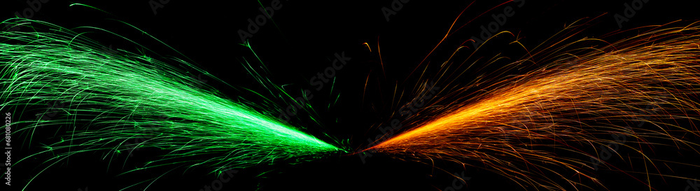 red and green fast-flying sparks from angle grinders on black background red and green fast-flying sparks from angle grinders on black background