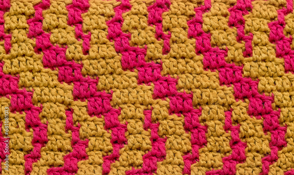 Crochet background. Abstract mosaic magenta yellow pattern close up. Curly pattern.