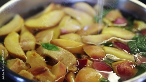 Pot with freshly brewed compote. Delicious fruit compote. Compote of peaches