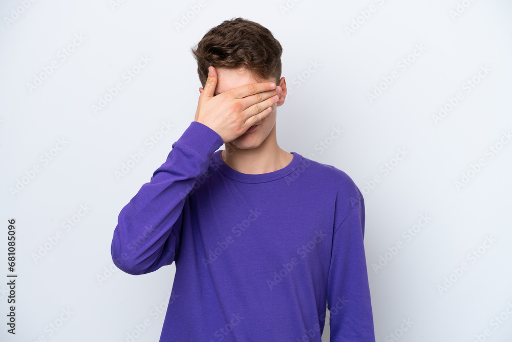 Teenager Russian man isolated on white background covering eyes by hands. Do not want to see something Teenager Russian man isolated on white background covering eyes by hands. Do not want to see something