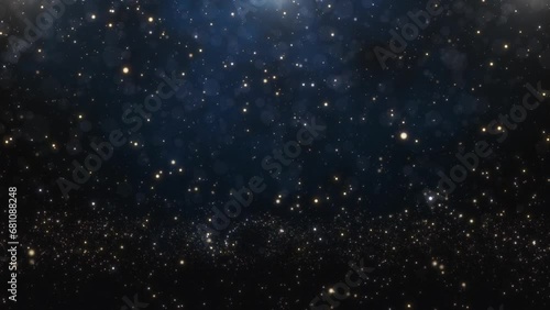 This is a festive background with falling shimmering golden particles on a dark blue background. photo