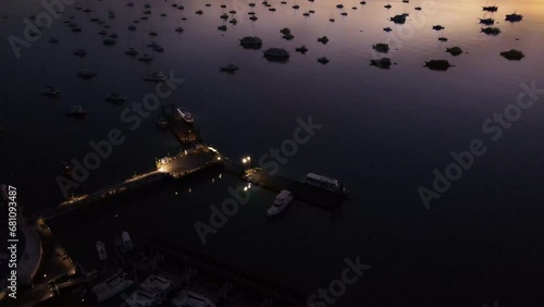 Wallpaper Mural Aerial drone view of illuminated Chalong Pier at dawn in Phuket, Thailand. Many boats, yachts and speed boats moored at the pier platform of Ao Chalong Bay, one of centers to travel around Andaman Sea Torontodigital.ca