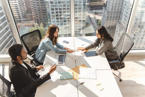 Group of successful managers planning project, startup, working together in modern office