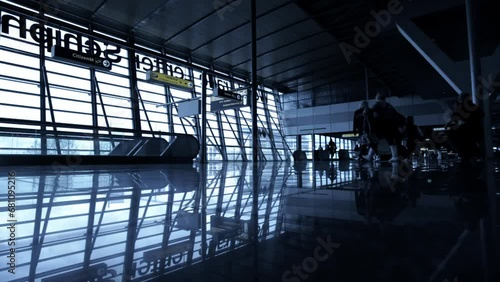 Travelers silhouettes at airport hall 
