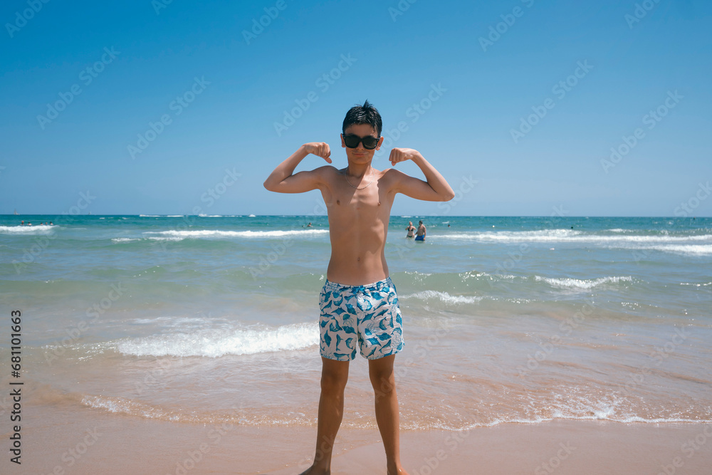 Teenage girl enjoying a fabulous day at the beach. She shows the strong arms of her. Teenage girl enjoying a fabulous day at the beach. She shows the strong arms of her.