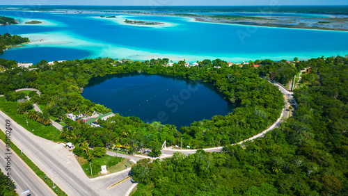 drone revealing cenote in Bacalar Mexico with 7 colours lagoon quintana roo riviera Maya travel destination Mexican resort beach  photo