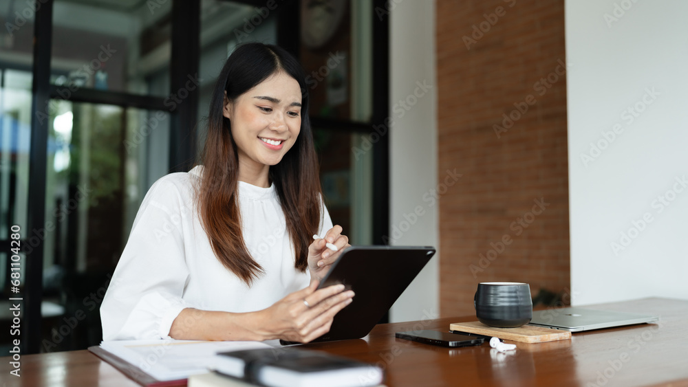 Writer woman is thinking creative ideas and writing business information content on tablet in cafe Writer woman is thinking creative ideas and writing business information content on tablet in cafe